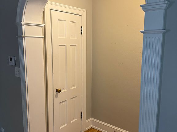 Front foyer entry with coat closet and beautiful arched doorway