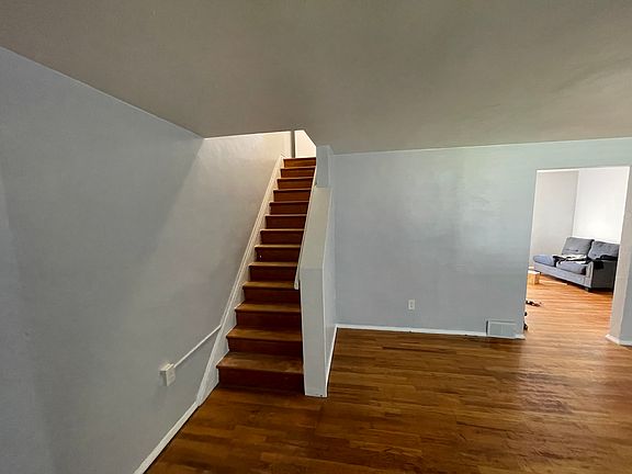 Stairs to left, opening to dining room on right