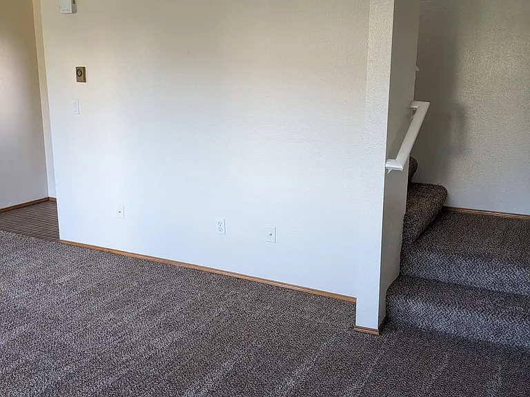 Stairway from living room to 3 bedrooms and 2 bathrooms