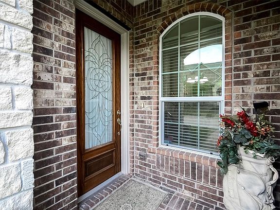 What a welcoming entry enhanced with dark stained front door and beveled glass detail.