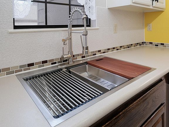 You will love all of the counter space, the handy cutting/washing/draining accessories of the sink, and the extra deep single basin ... perfect for deep pots