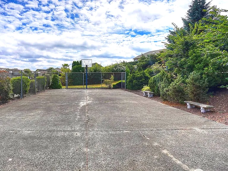 Metal fenced & Landscaped Sports Court in Large Backyard