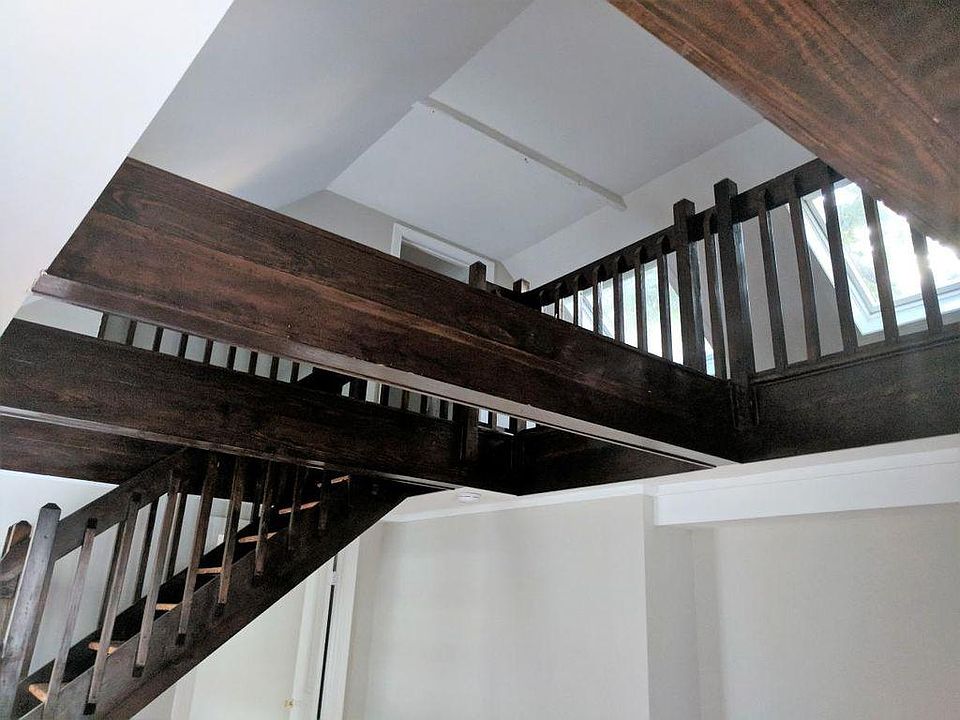 Looking up from the living room towards the loft and second bedroom.