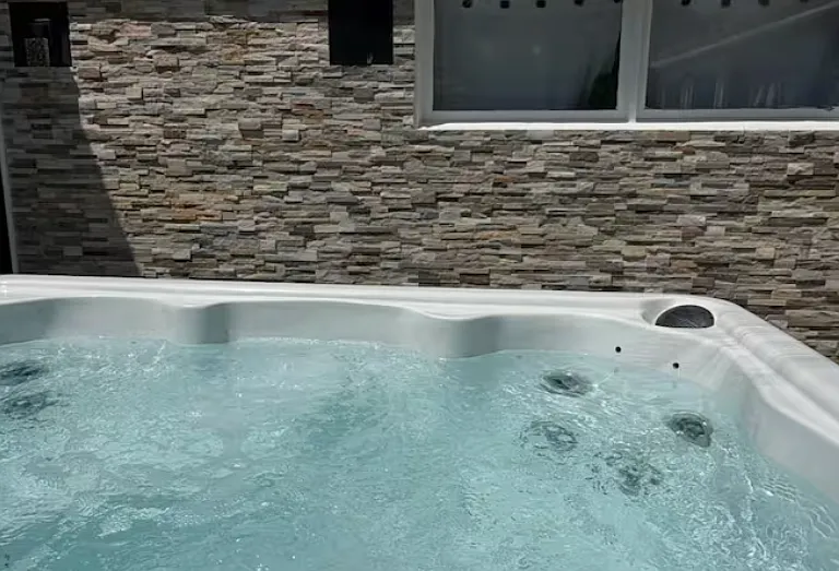 Relaxing outdoor hot tub _ a premium amenity for unwinding after long days or hosting guests.