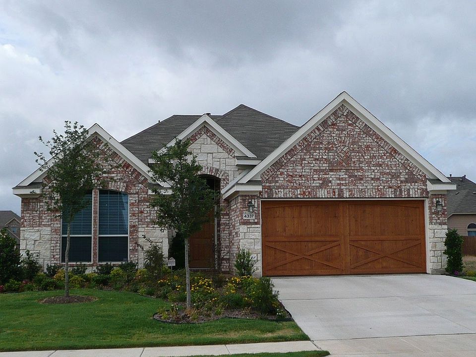 Beautiful Brick Home with Stone Accents and Custom Cedar Garage Doors