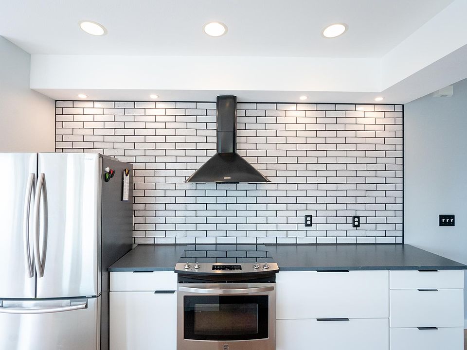 Electric range, Refrigerator/freezer with ice maker, quartz counters, thin brick backsplash