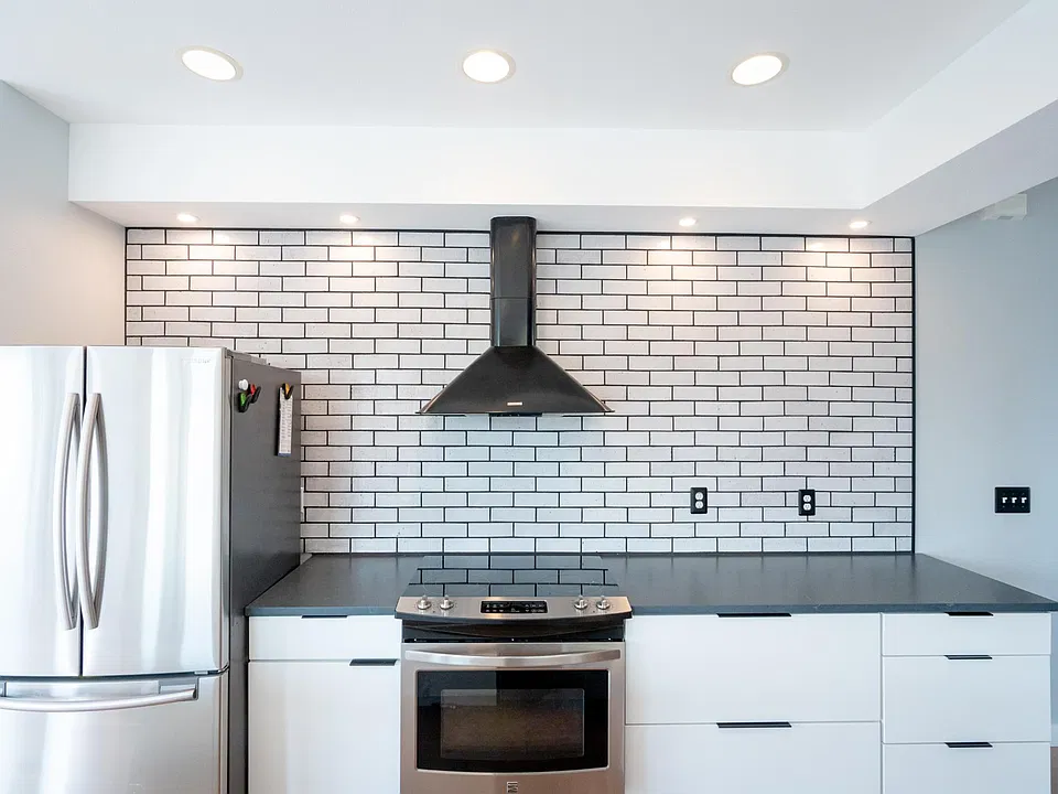Electric range, Refrigerator/freezer with ice maker, quartz counters, thin brick backsplash