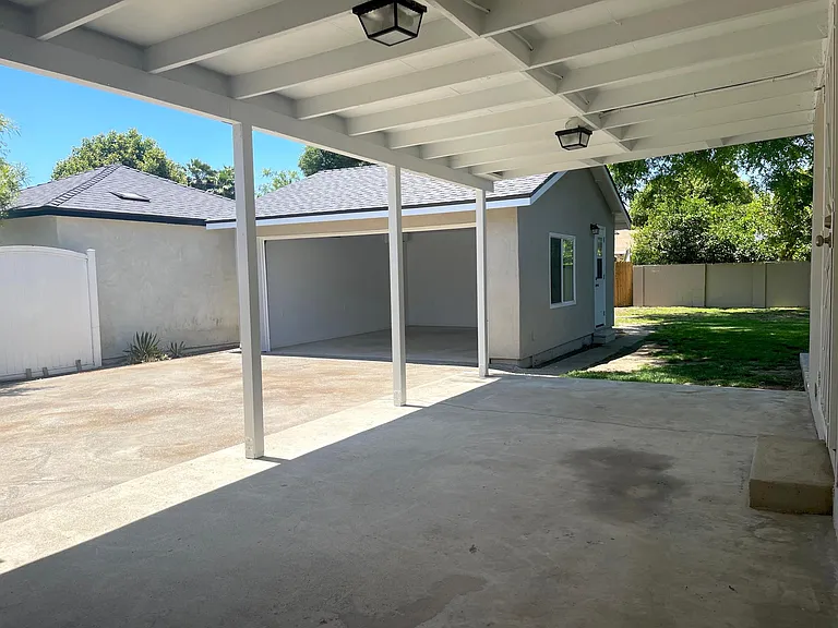 Covered patio great for entertaining with access from both main bedroom and den.
