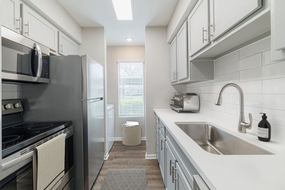 Kitchen with quartz countertops and stainless steel appliances