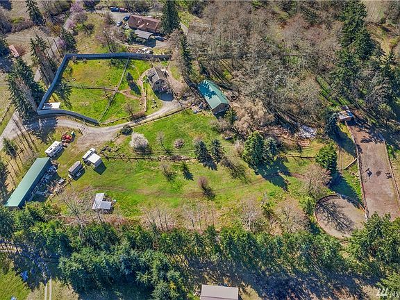 Aerial of improved parcel - fully fenced, extensive kennel fencing, barn with pasture, training arena, horse enclosure, paddocks, pond, functioning kennel, studio, main home....pretty great piece of property (and this photo doesn't include the almost 5 acres of vacant land across the street!)