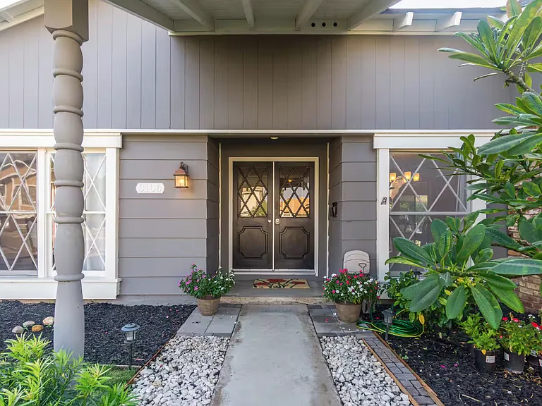This is the entrance door with new double pane windows and lots of flowers. The fragrant gardenia will greet visitors during the months of May, June and July!