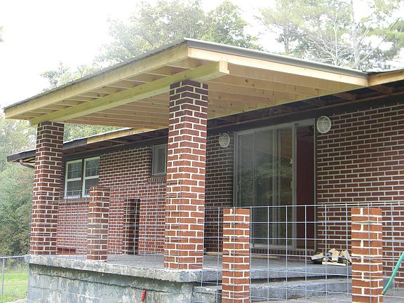 Back porch with view of woods and new covered roof