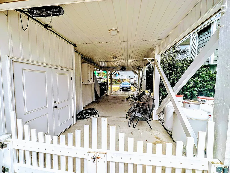 Long shot of side yard seating area with Built In TV