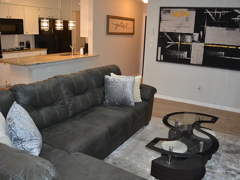 Unwind in a spacious, open-concept living room featuring plenty of comfortable seating meaning there is room for everyone to relax and make lasting memories together.