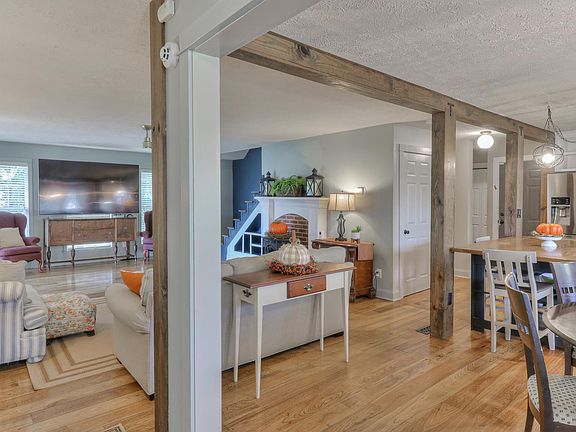 Large living room with fireplace- close to kitchen and dining