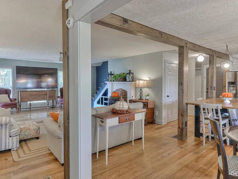 Large living room with fireplace- close to kitchen and dining