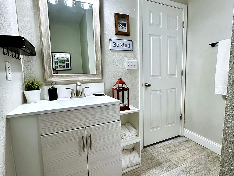 Spacious bathroom with oversized shower and vanity for storage