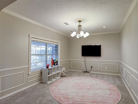 This is the other side of the large double room off of the front door, it is currently used as a game room.