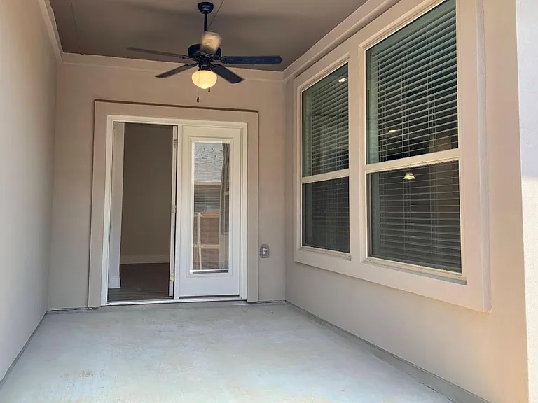 Side patio has light and ceiling fan. Set up your own cozy outdoor living space.