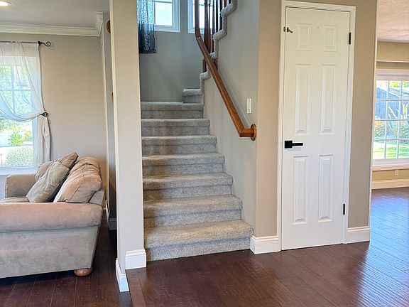 Entry with stairs to second floor, step down living room on the left