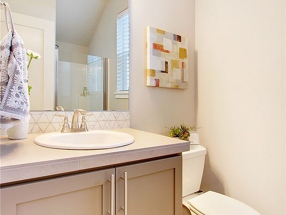 3/4 bathroom on main.  Photos of another 2273 at another Harbour Homes community. Details and color selections will vary.