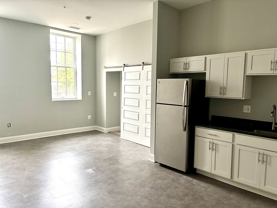 Barn door separates the hallway from the living area. The hallway has a large closet across from the bathroom and leads to the bedroom.