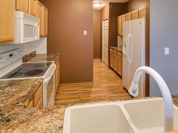 Kitchen has extended cabinetry area to provide abundant storage.