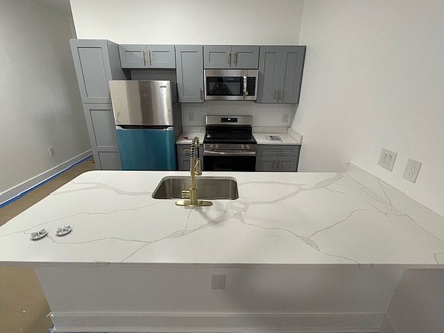 Renovated Kitchen with stainless appliances and sleek modern fixtures.