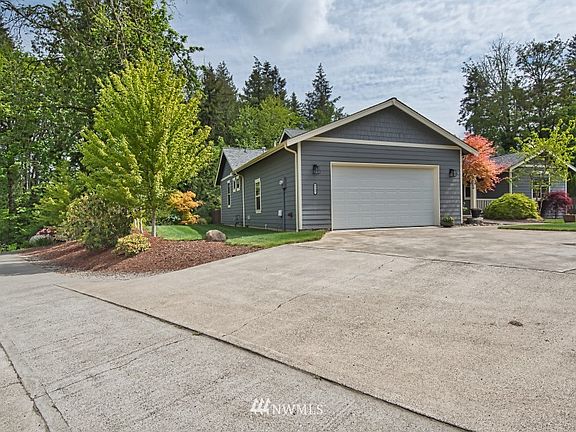 Concrete drive makes this corner lot shine