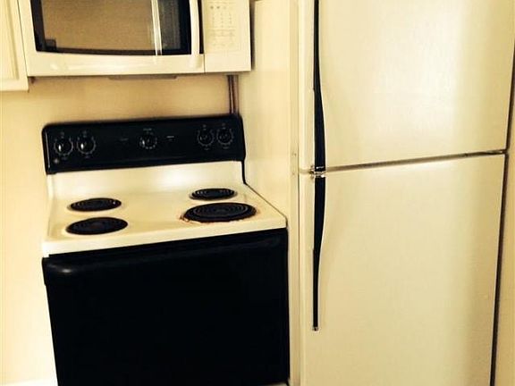 Newly renovated kitchen includes refrigerator, stove, and mi