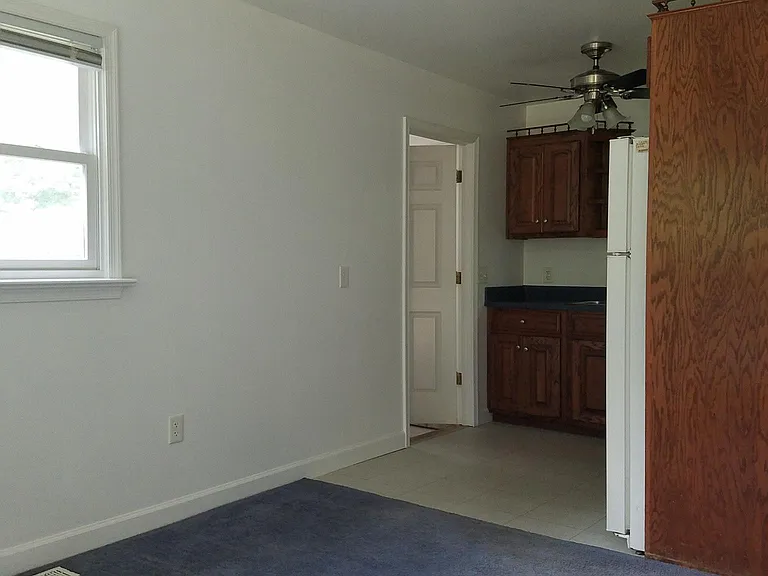 Living room at entrance, kitchen up ahead, with laundry room door on the left of kitchen.