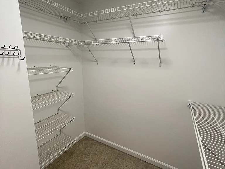 Walk-in closet with shoe storage (on left)