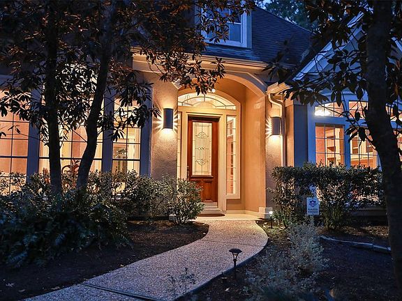 From the extra wide driveway, the tree lined walk leads you to a warm and welcoming covered porch.