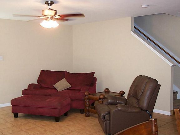 View of living or den showing the stairway leading to second floor