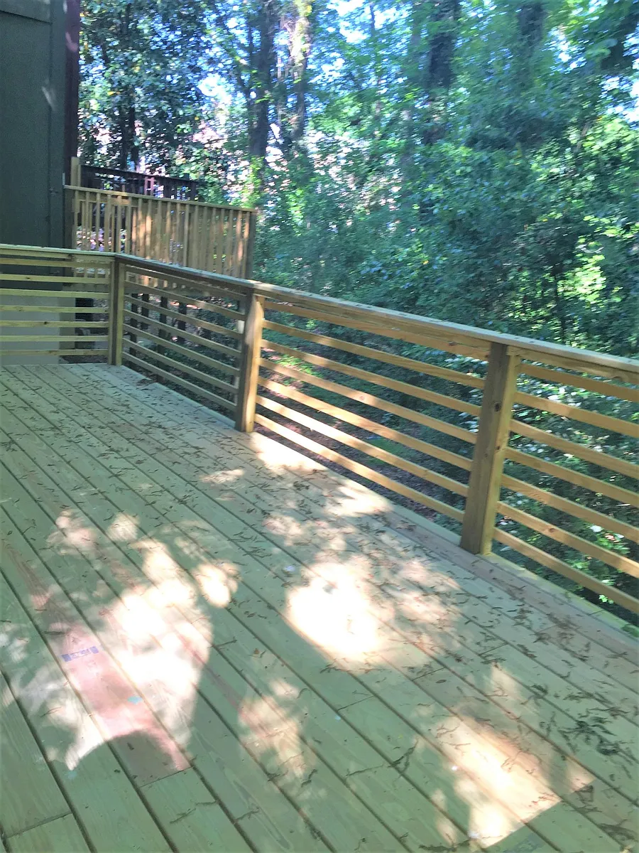 Deck on ground level, surrounded by trees - 157 Woodstone Dr