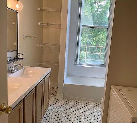 Newly renovated bathroom with washer and dryer in unit; option to remove