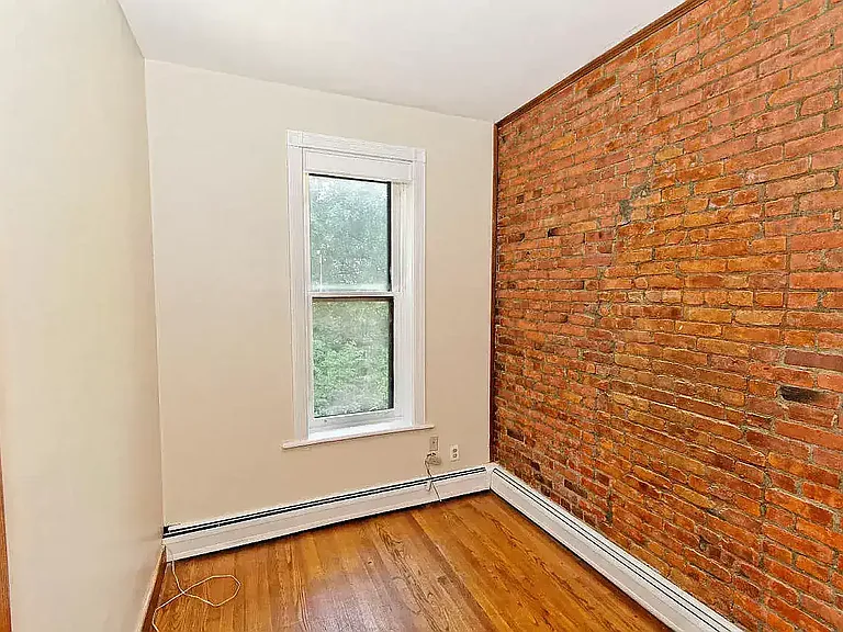 This is what you would call a nursery or office space. Also, there is that sweet brick wall again.