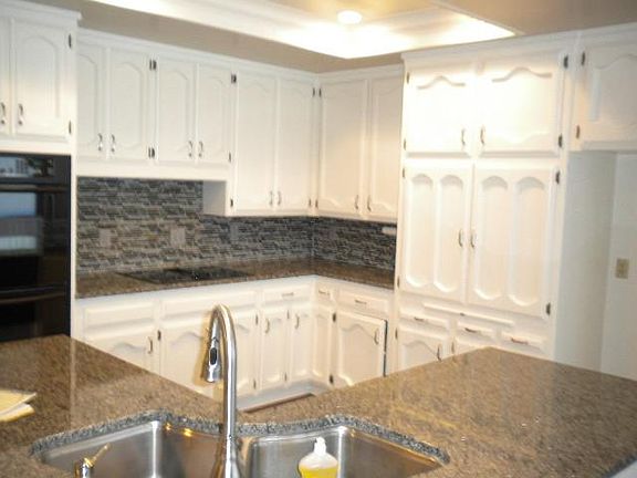WHITE CABINETS, BLACK APPLIANCES, GRANITE COUNTER TOPS. ELEC