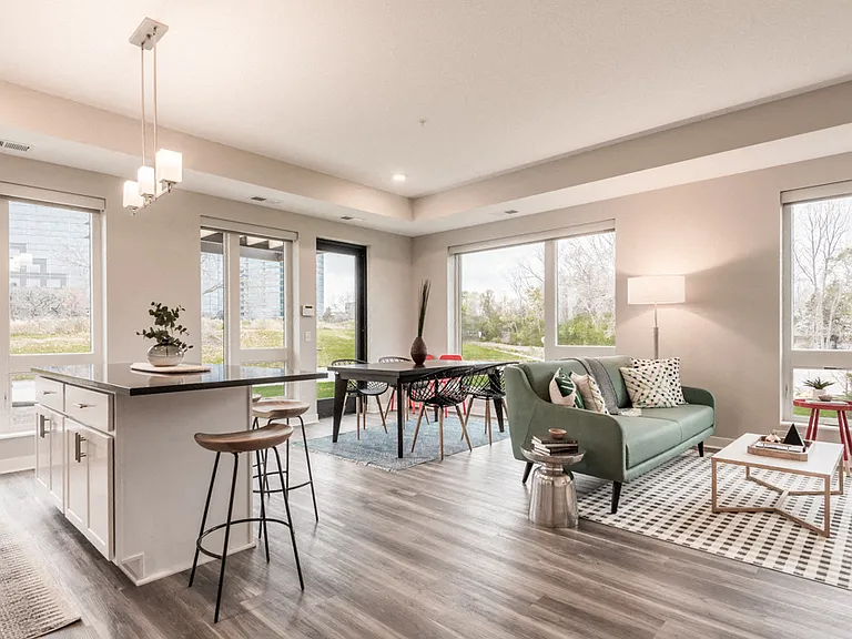 Large windows invite natural light, creating a bright and airy living space.