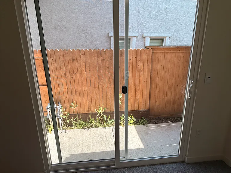 Siding door to some open space outside which is private