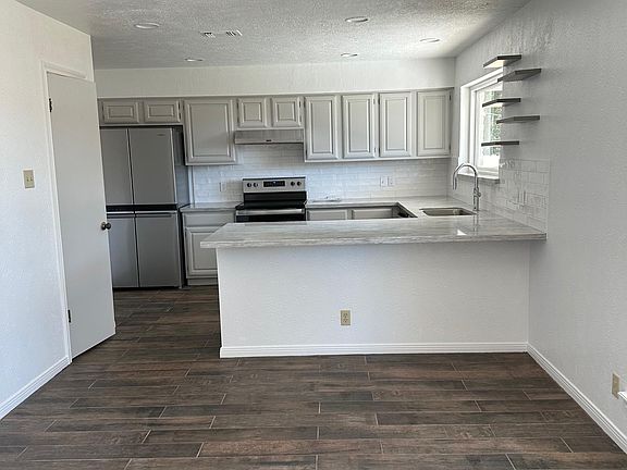 Kitchen newly painted cabinets new granite counters throughout the house & all new appliances