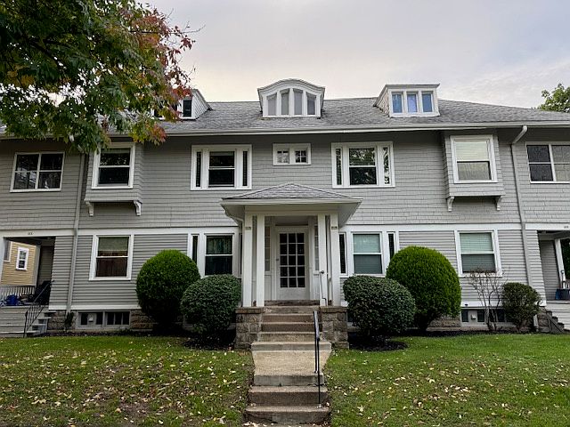 Mature shrubs and charming center entrance vestibule.