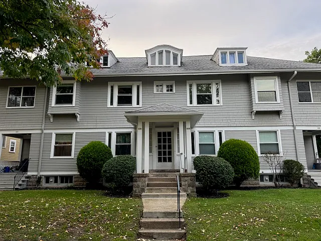 Mature shrubs and charming center entrance vestibule.