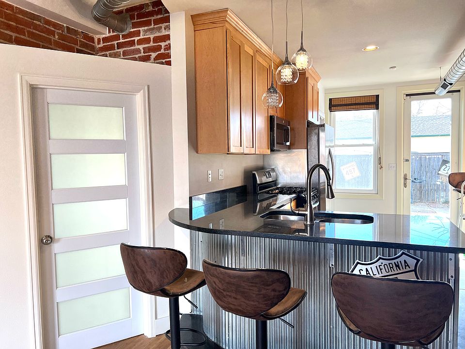 Kitchen countertop with bar stools included if desired.