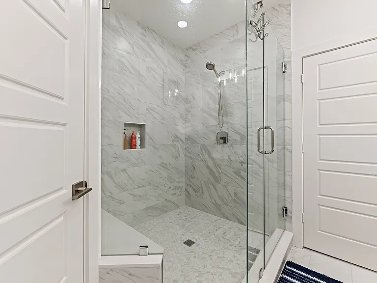 The huge shower even offers a tiled seat.
