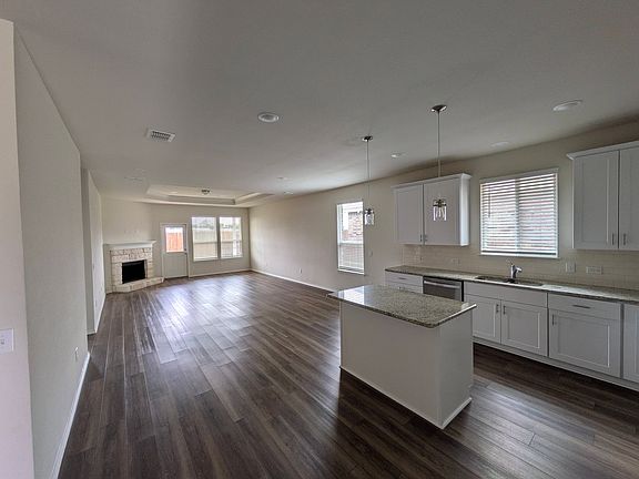 spacious and high ceiling of living and dining space open to kitchen, with recess lights