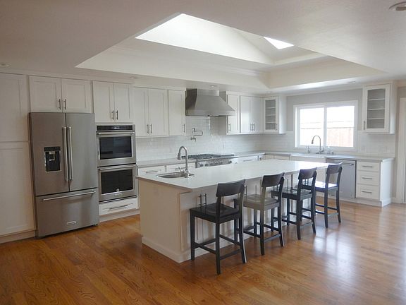 Well Equipped Kitchen with 3 Dramatic Skylights and 4x17 Island Bar with Marble Counter