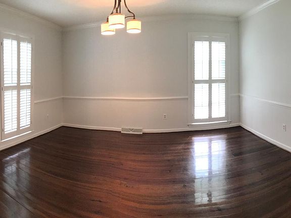 Dining room with heart of pine flooring and plantation shutters