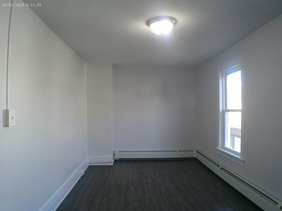 Large bedroom with two large closets in hallway.