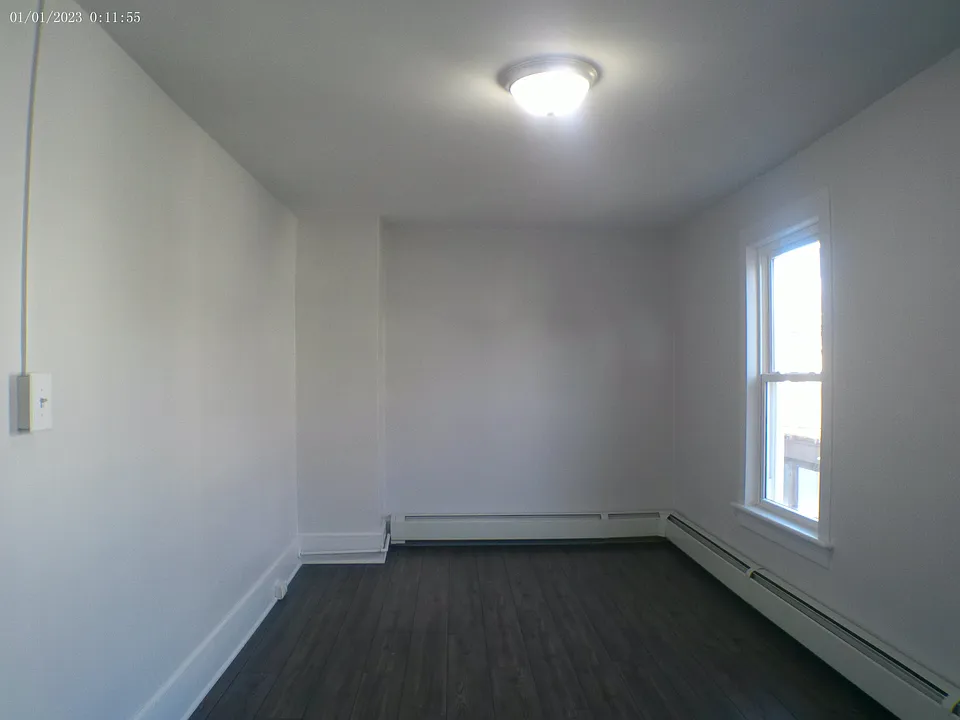 Large bedroom with two large closets in hallway.